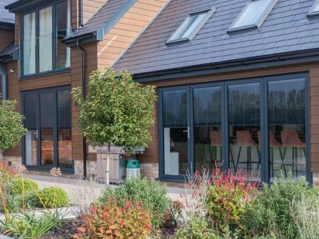Anthracite aluminium sliding doors on a modern extension