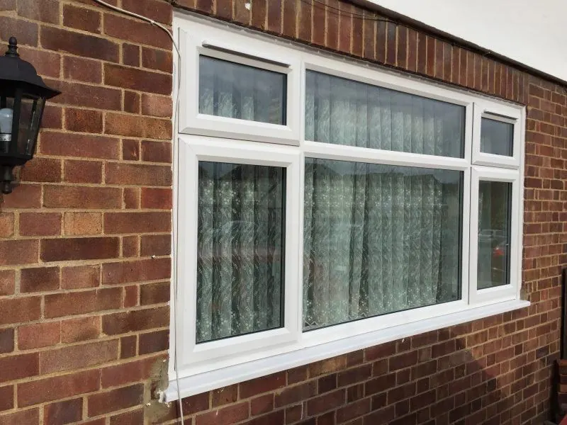 White uPVC casement windows on a brick house