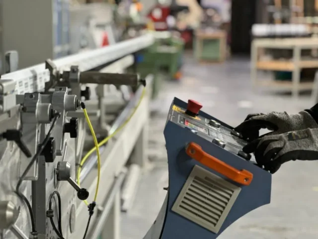 Operator at a uPVC welding machine in the Ada Windows factory
