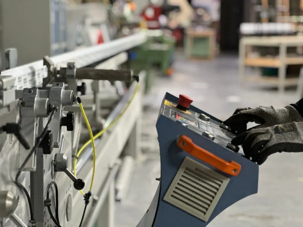 Operator at a uPVC welding machine in the Ada Windows factory