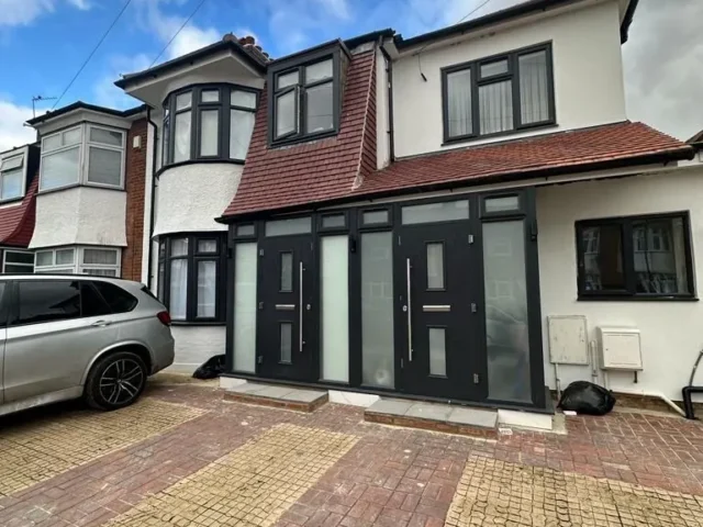 Grey flush casement windows on a detached house