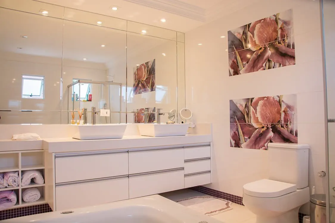 Wall-to-wall mirror above a bathroom vanity