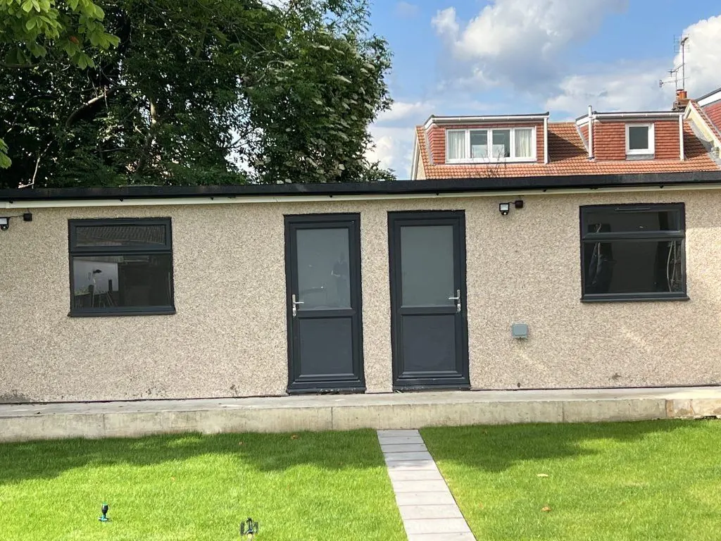 Grey aluminium doors on a garden annexe