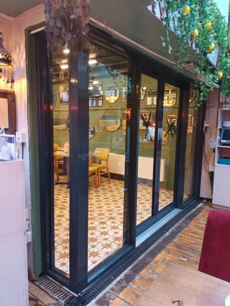 Black aluminium shopfront doors on a café — Aluminium shopfronts in White Hart Lane