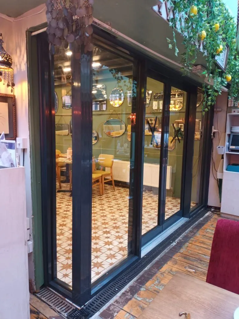 Black aluminium shopfront doors on a café