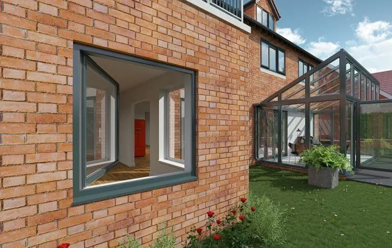 Grey tilt and turn window open on a brick house