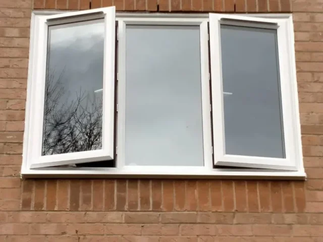 White upvc casement window fitted in a red brick wall