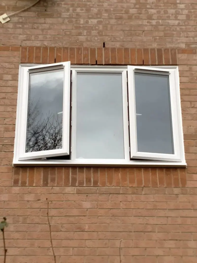 White uPVC casement window fitted in a red brick wall